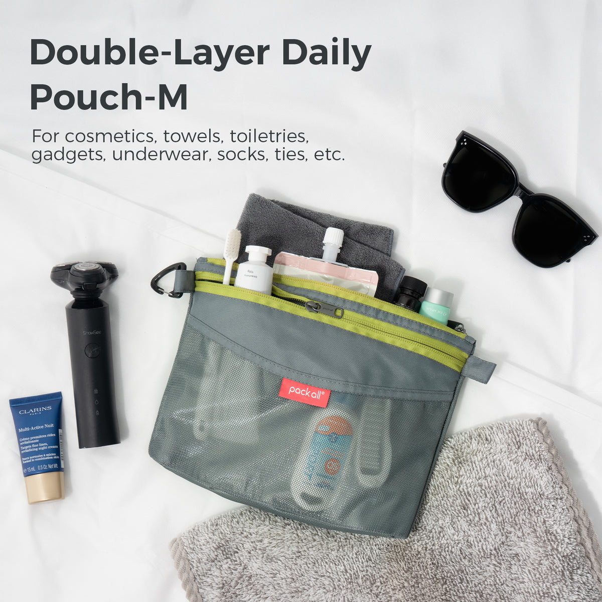 pack all® gray medium double-layer daily pouch shown with makeup, toiletries and personal care items arranged around and inside the bag.